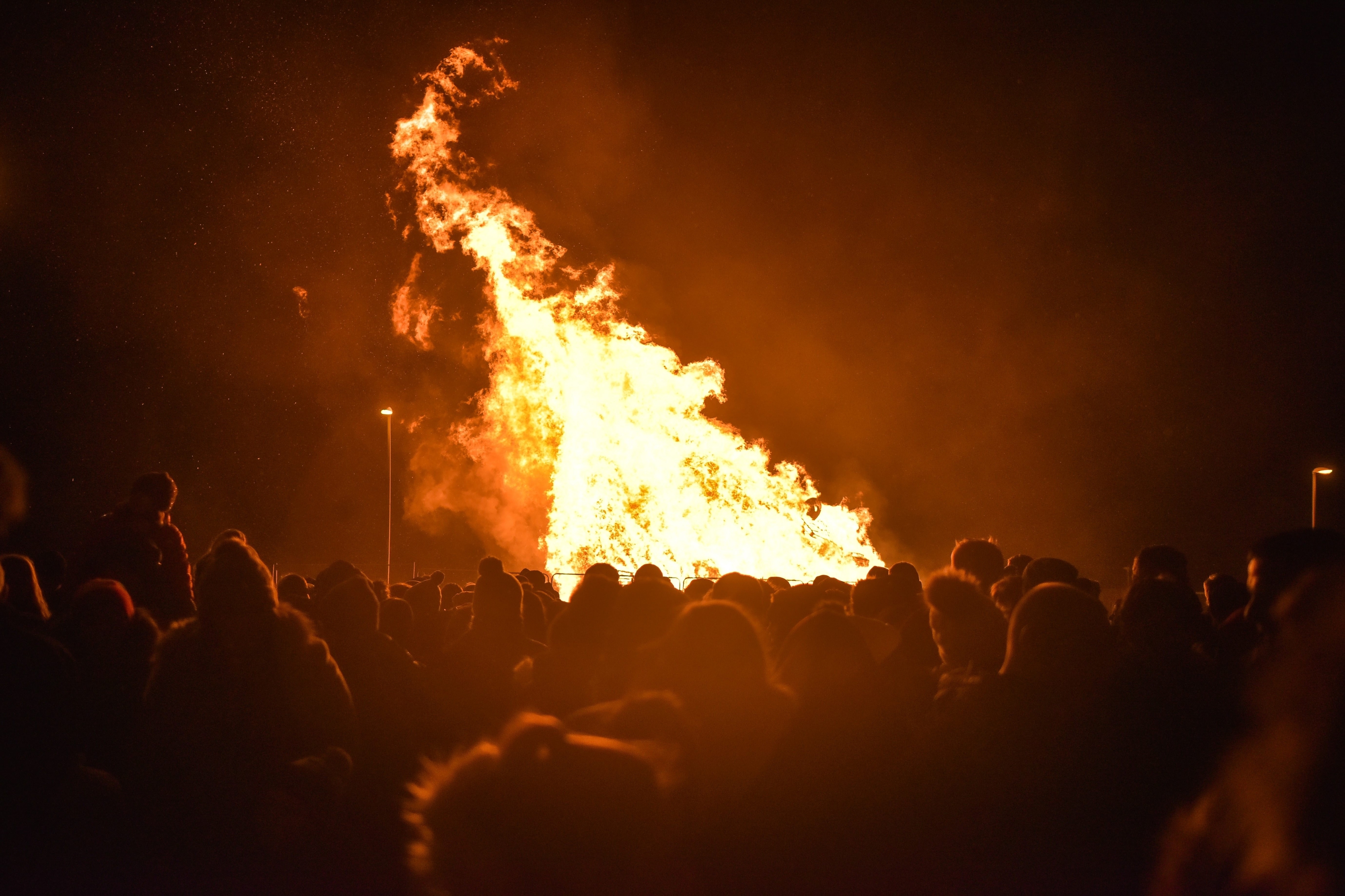 Members of the public gather to watch the bonfire in Peterhead, Aberdeenshire on November 05 2015. Events are being held across the country tonight, Thurs November 05, to mark Guy Fawkes Day. The bonfire in Peterhead, Aberdeenshire, which is created by pallets and other large wooden objects, is thought to be one of the biggest in Scotland. It's estimated to stand at over 20 feet tall.