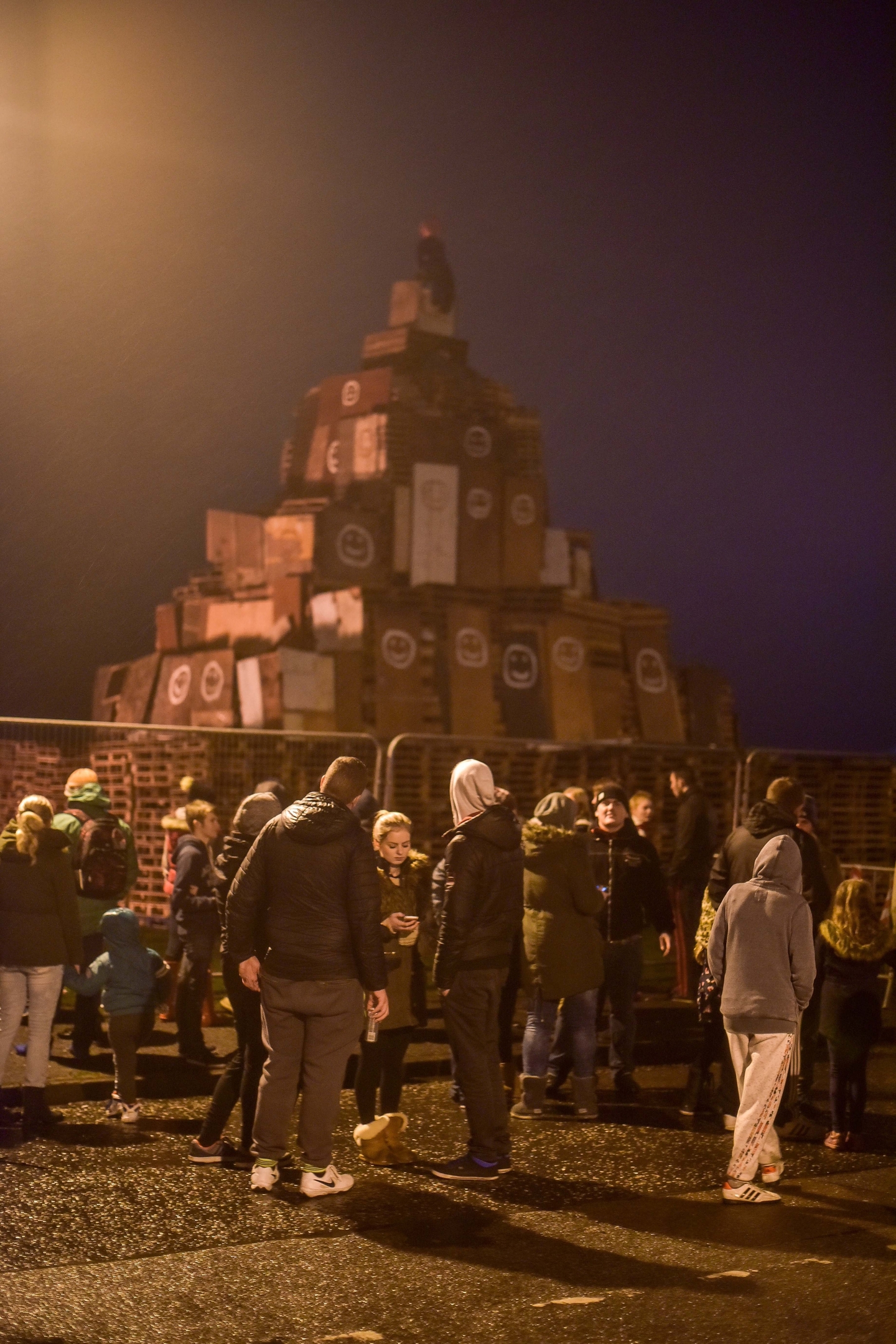 Members of the public gather in front of the bonfire in Peterhead, Aberdeenshire on November 05 2015. Events are being held across the country tonight, Thurs November 05, to mark Guy Fawkes Day. The bonfire in Peterhead, Aberdeenshire, which is created by pallets and other large wooden objects, is thought to be one of the biggest in Scotland. It's estimated to stand at over 20 feet tall.