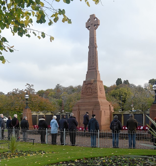 Members of the public observe the silence at the Cenotaph in Cavell Gardens