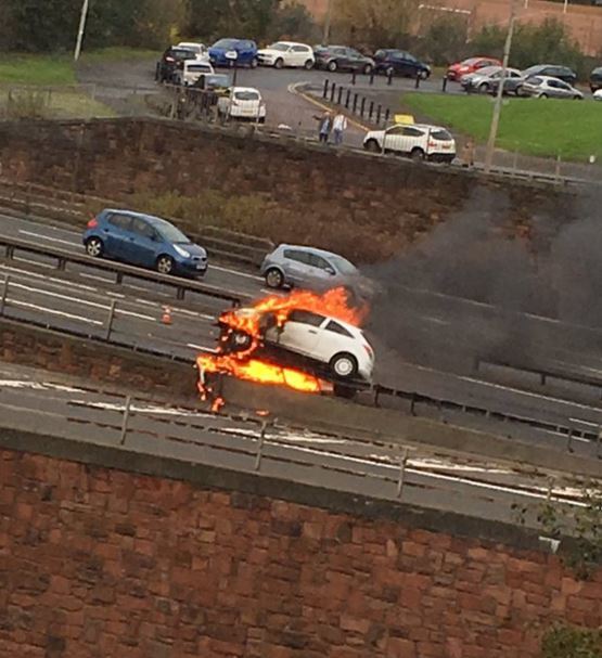 The car on fire on the M8 barrier. Picture courtesy of Twitter user @Parke200