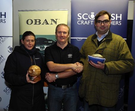 Oban distillery manager Les Aitken(centre) with husband and wife team Nigel and Helen Ovens