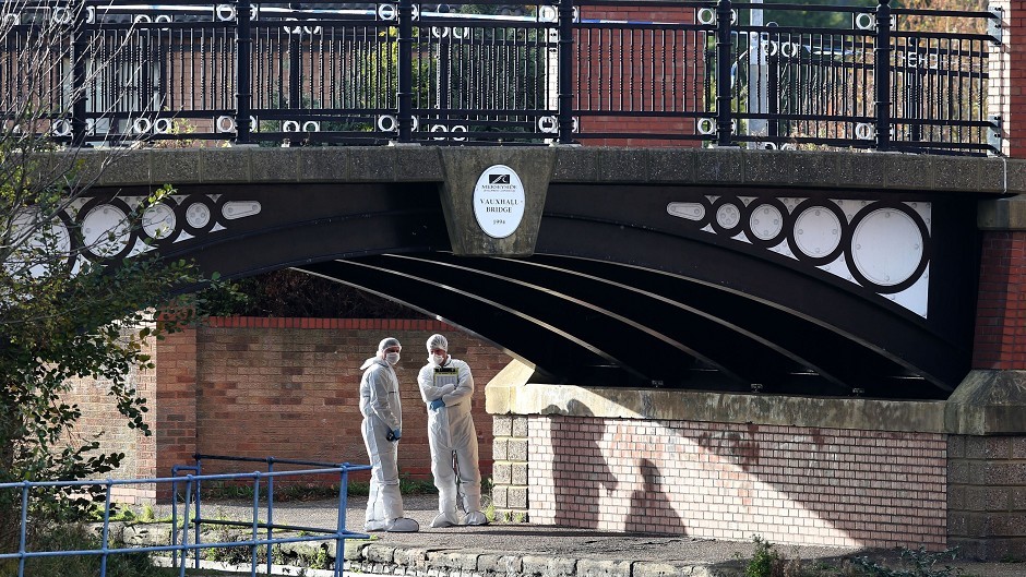 Merseyside Police forensic team members examine the scene where the 16-year-old boy was shot near Eldonian Village, in the Vauxhall area of Liverpool
