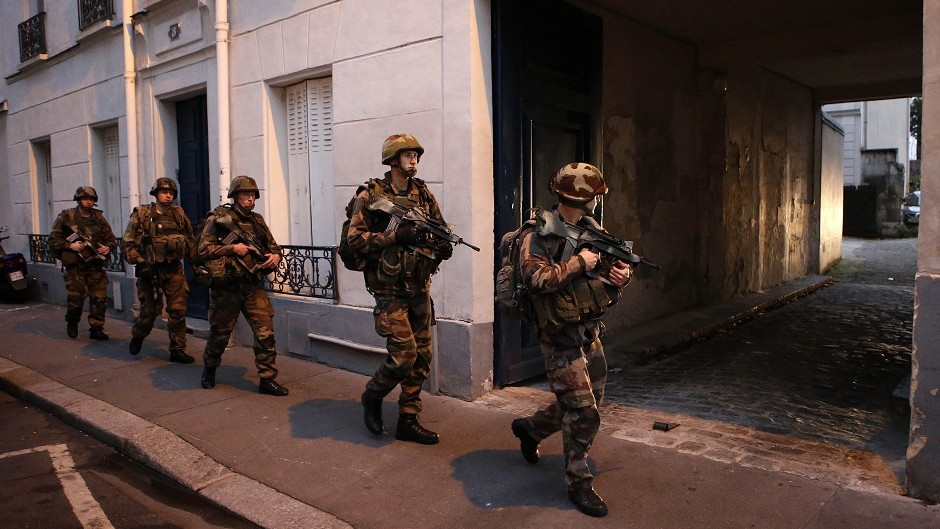 Soldiers operate in St Denis, a northern suburb of Paris (AP)
