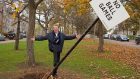 Former footballer Denis Law pictured with one of Aberdeen's No Ball Games signs