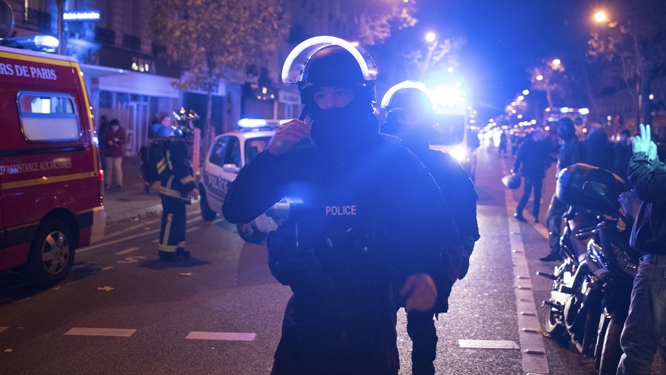 Elite police officers arrive outside the Bataclan theatre in Paris (AP)