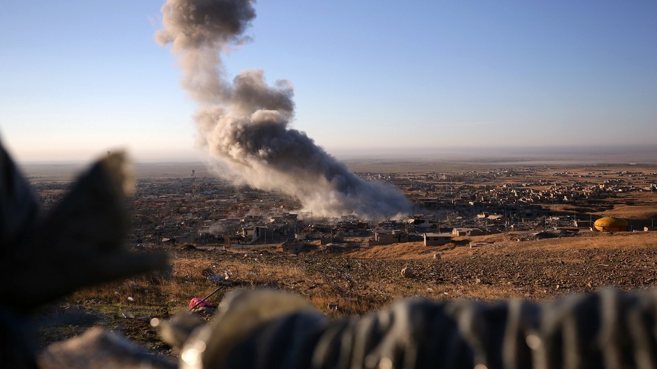 Smoke believed to be from an airstrike billows over the northern Iraqi town of Sinjar (AP)