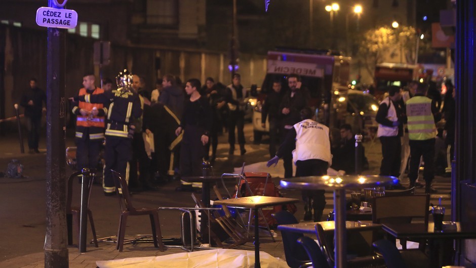 Rescue workers and medics in a Paris restaurant where the first shootings were reported (AP)