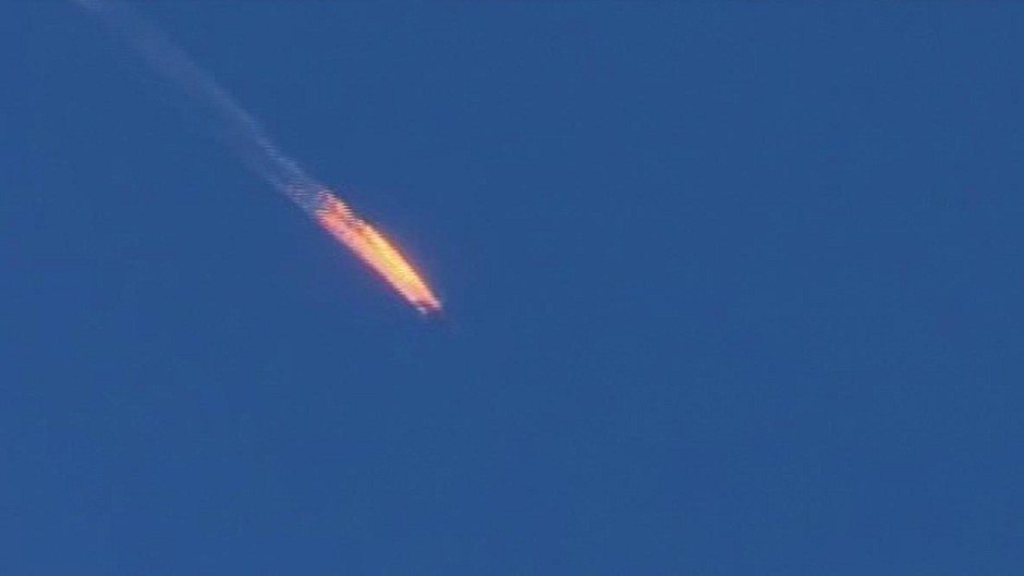 A Russian warplane on fire before crashing in Turkey after being shot down (Haberturk TV via AP)