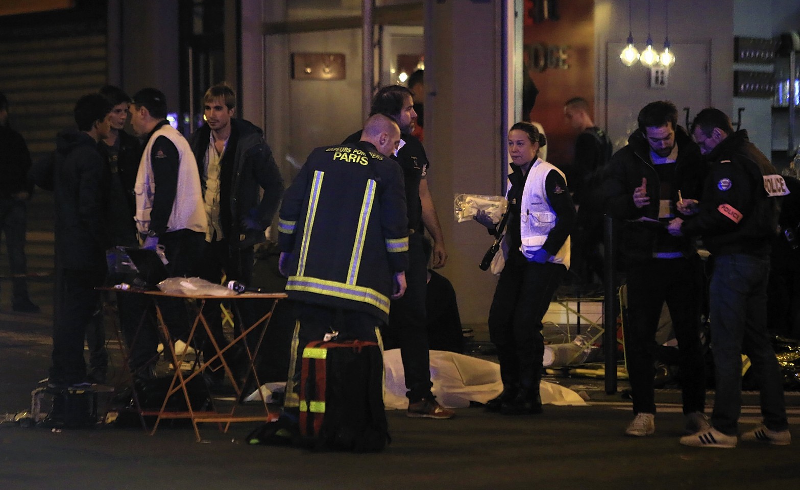 Rescue workers and medics work by victims in Paris