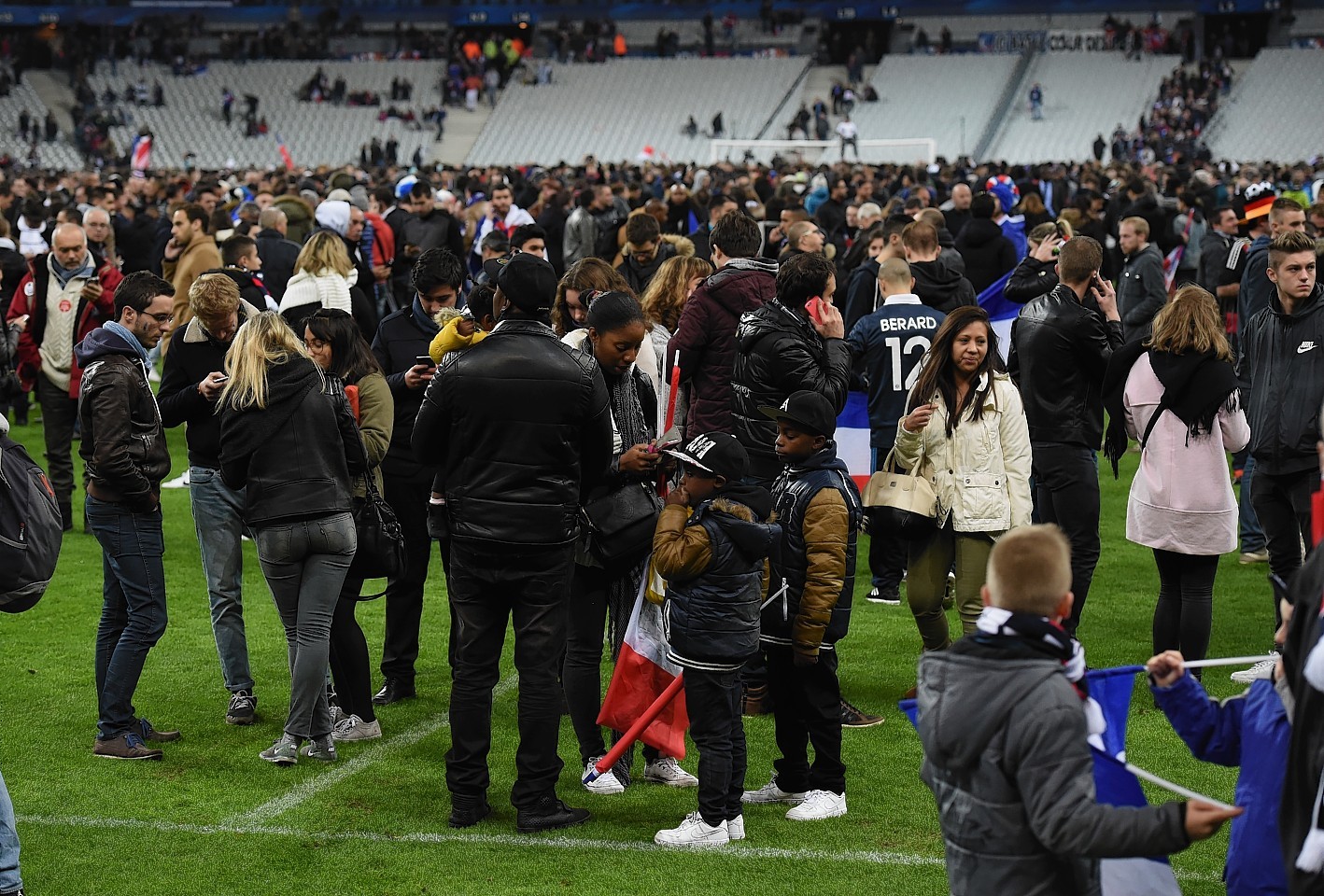 Spectators gather on the pitch of the Stade de France stadium following the International Friendly match between France and Germany at the Stade de France