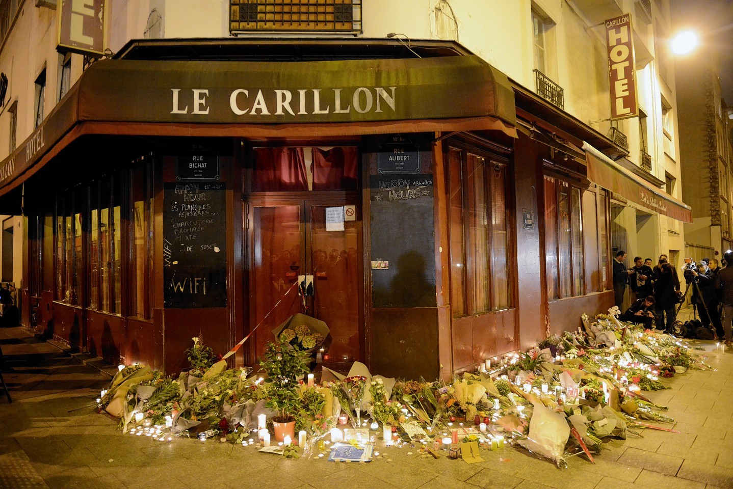 Flowers and candles have been placed outside Le Carillon bar, where some of the attacks were carried out