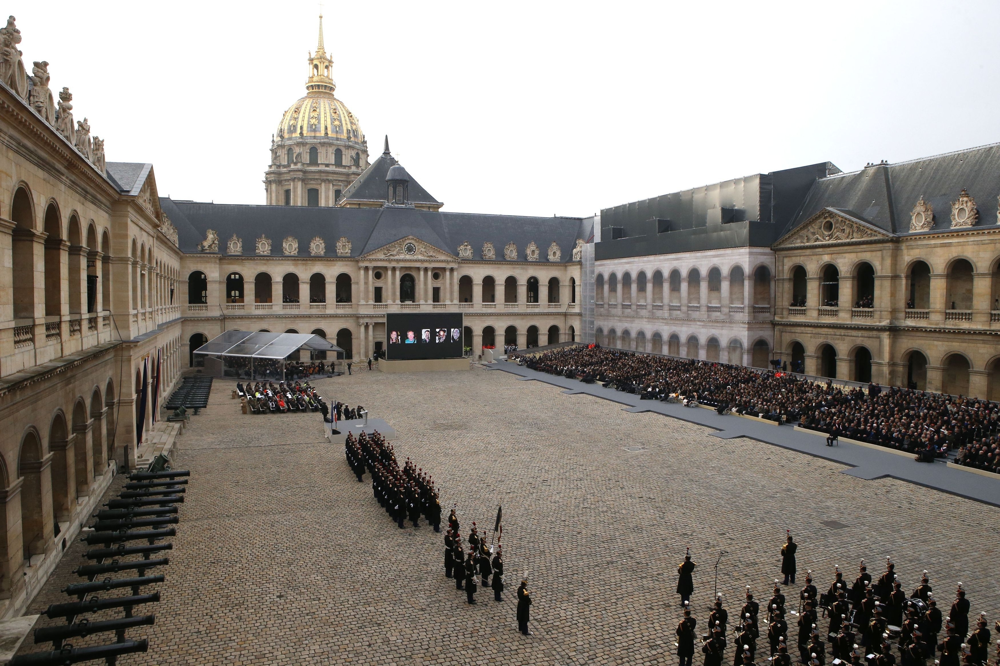 Guests, right, attend during a ceremony in the courtyard of the Invalides in Paris