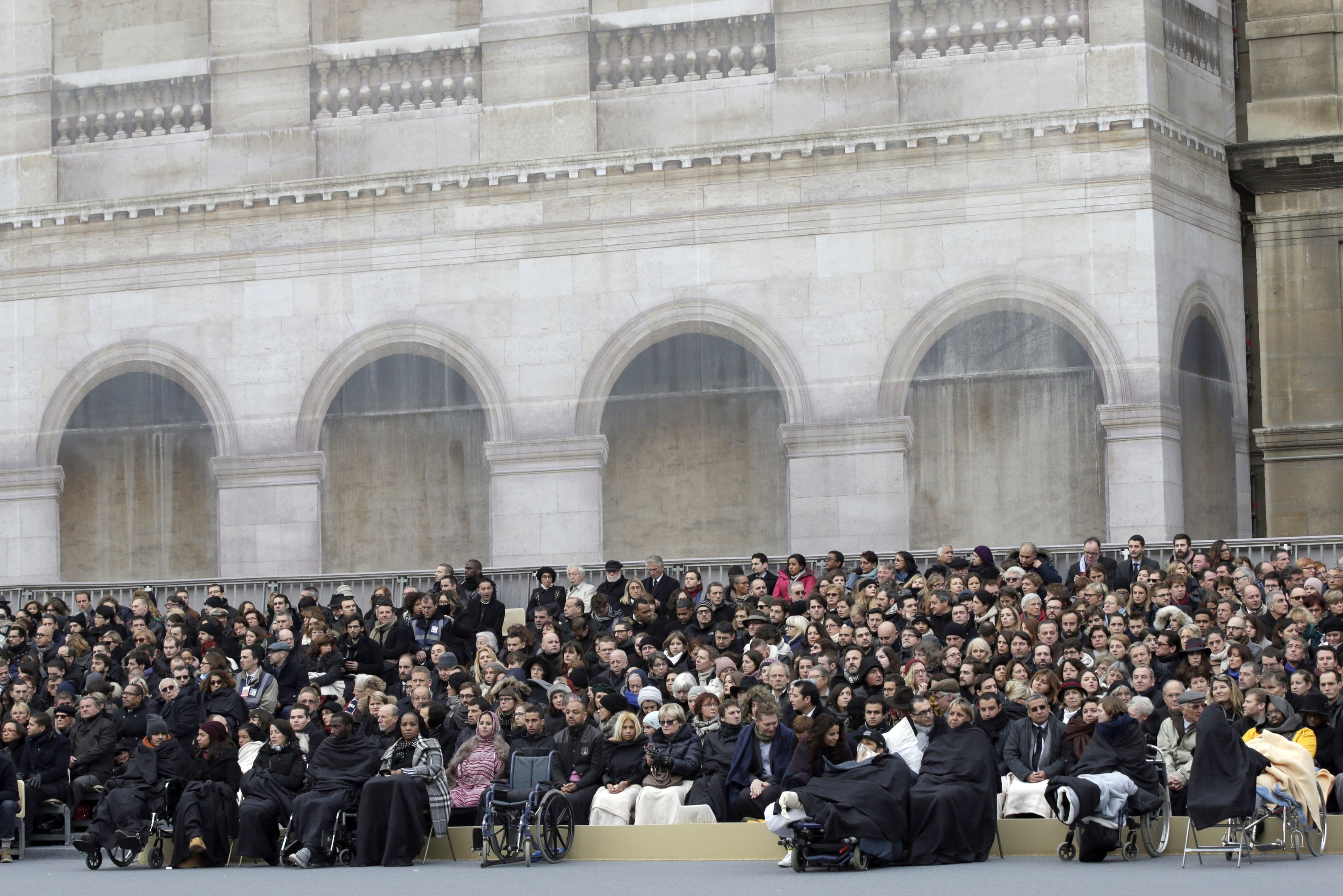 Families and relatives of the victims and people wounded during the attacks attend a ceremony to honor the 130 victims killed in the Nov. 13 attacks, in the courtyard of the Invalides in Paris, 