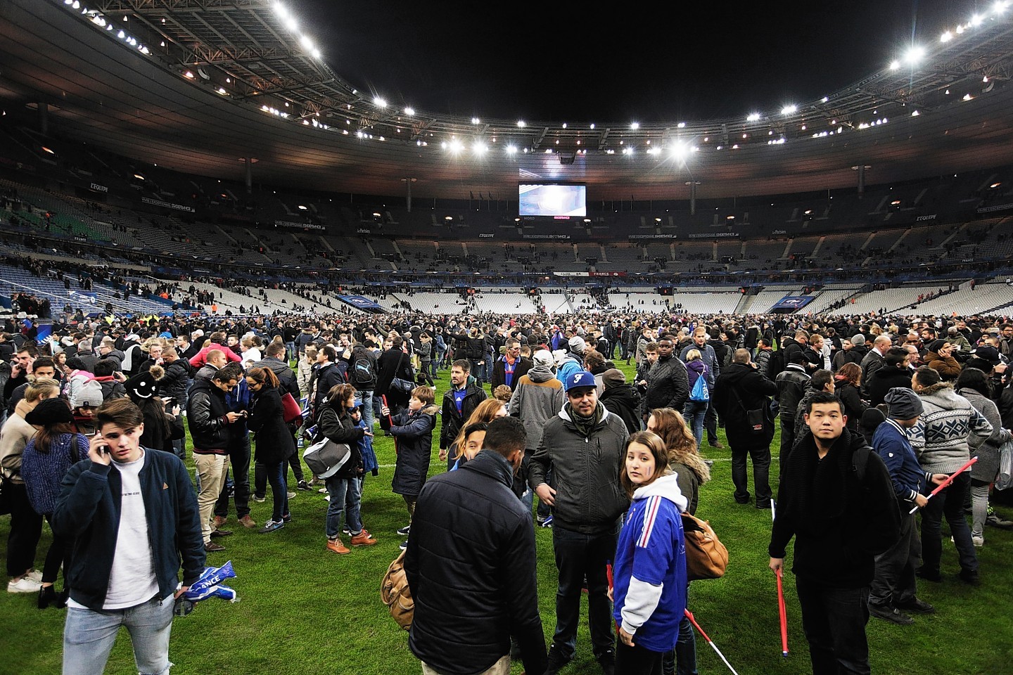 Thousands of fans at the Stade de France were forced onto the pitch following a series of explosions 