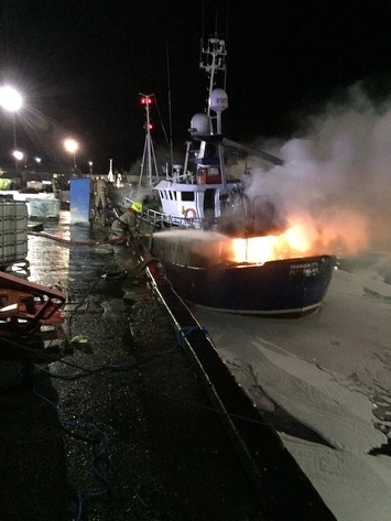 The boat on fire at the harbour