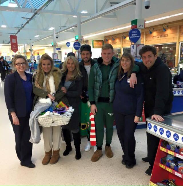 The cast pose for a picture inside the Inverness shop 