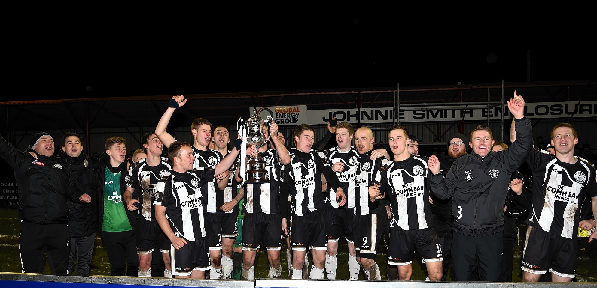 The Wick players celebrate with the trophy. Picture by Gordon Lennox