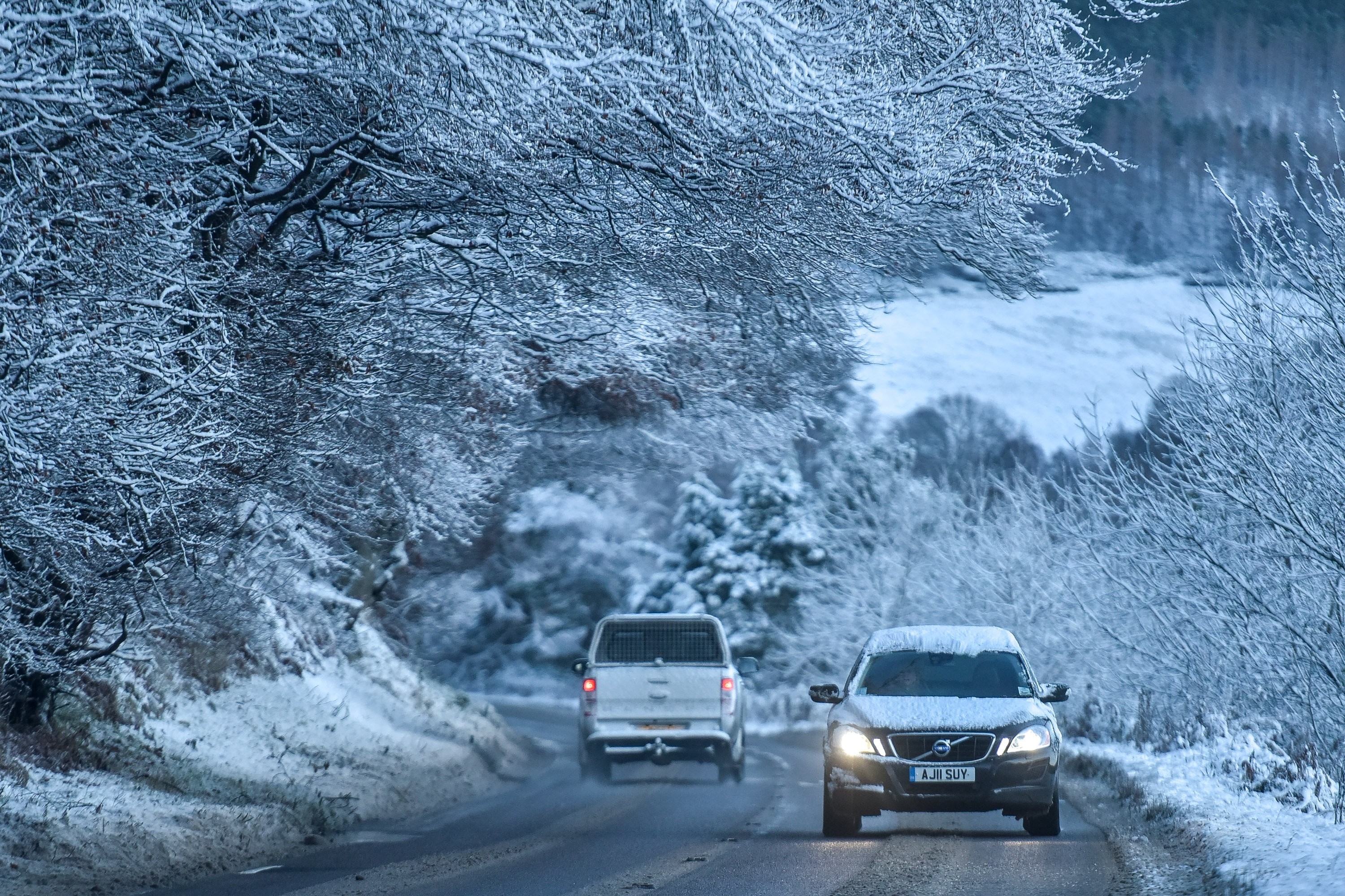 A car is seen driving in wintery conditions near Rothes, Moray on November 30 2015. Storm Clodagh has brought high winds and snow showers which covered the north of Scotland.