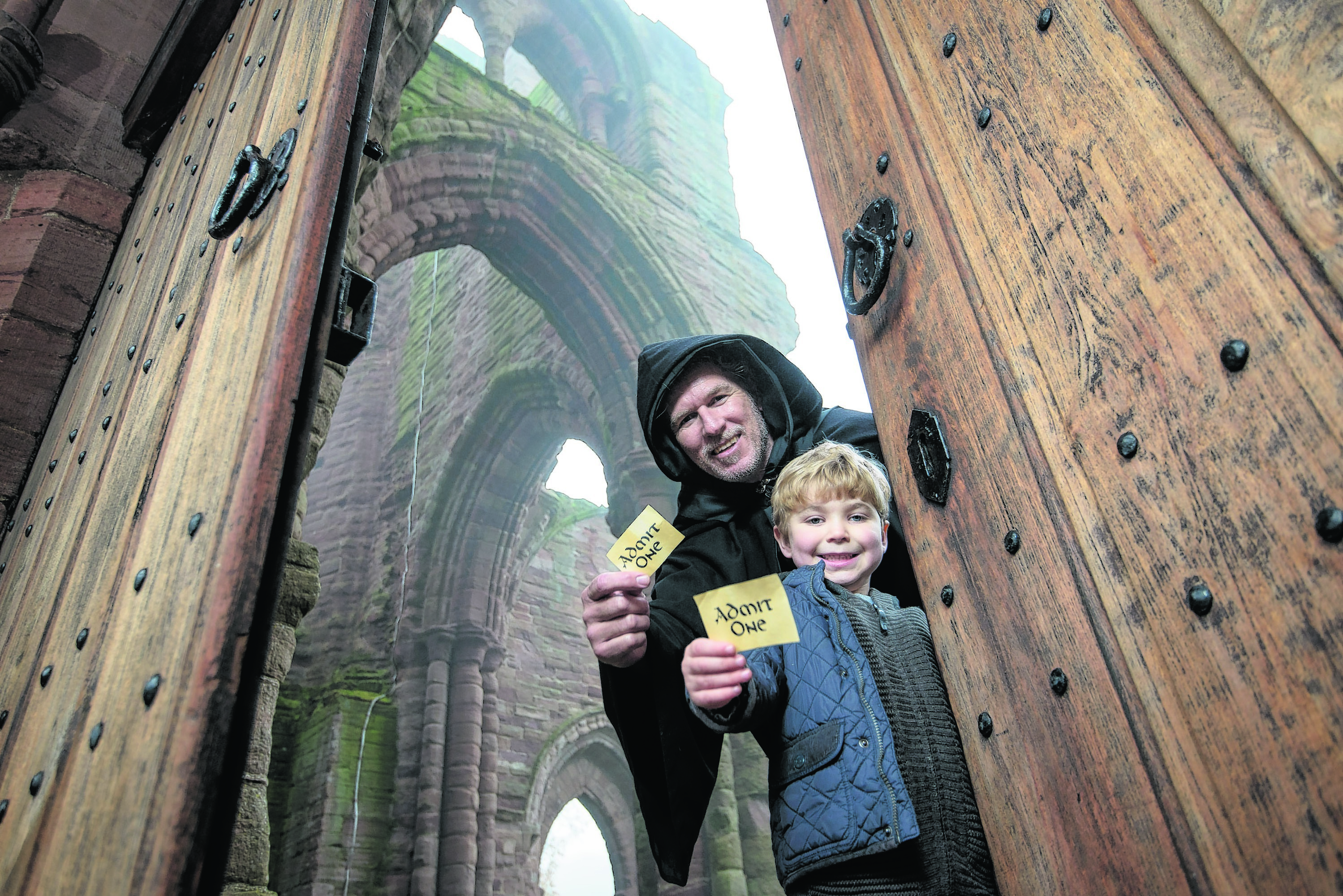Bruce Fraser, 5, from Dundee, is shown around Arbroath Abbey by one of the monks from its past (played by Marcus McLeod) to help launch this year’s Ticket Giveaway weekend, which takes place this Saturday and Sunday, November 28 and 29. Photo: Historic Scotland
