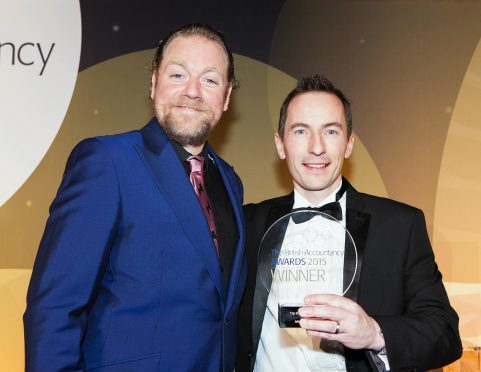 Johnston Carmichael’s Donald McNaught, right, picks up the award for restructuring project of the year, with Rufus Hound, at the British Accountancy Awards