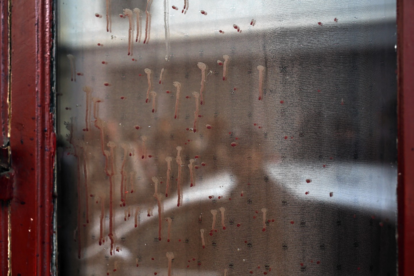 Dried blood can be seen on the window of the Carillon cafe in Paris 