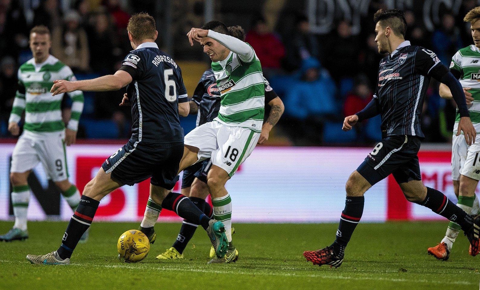 Chris Robertson challenges Celtic's Tom Rogic