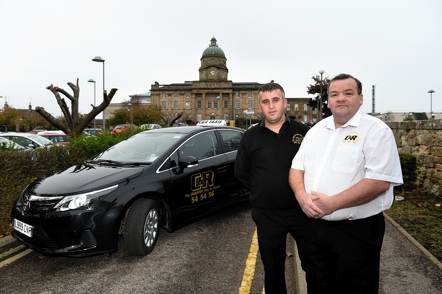 C&R Taxis boss Rod McLennan (white shirt) and driver Osman Kahraman. Picture by Kenny Elrick