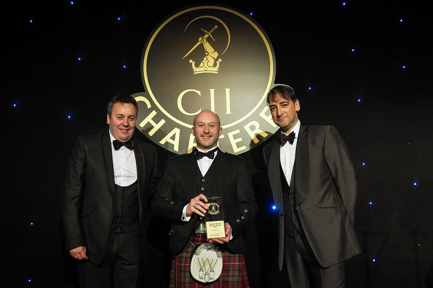 Simon Glazier, Andrew Megson, retirement managing director at financial services firm Partnership, and Alistair McCowan at the Chartered Awards