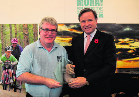 Angus Gordon-Lennox, right, receiving the Tourism Business Award from Cameron Taylor, of MoraySpeyside Tourism