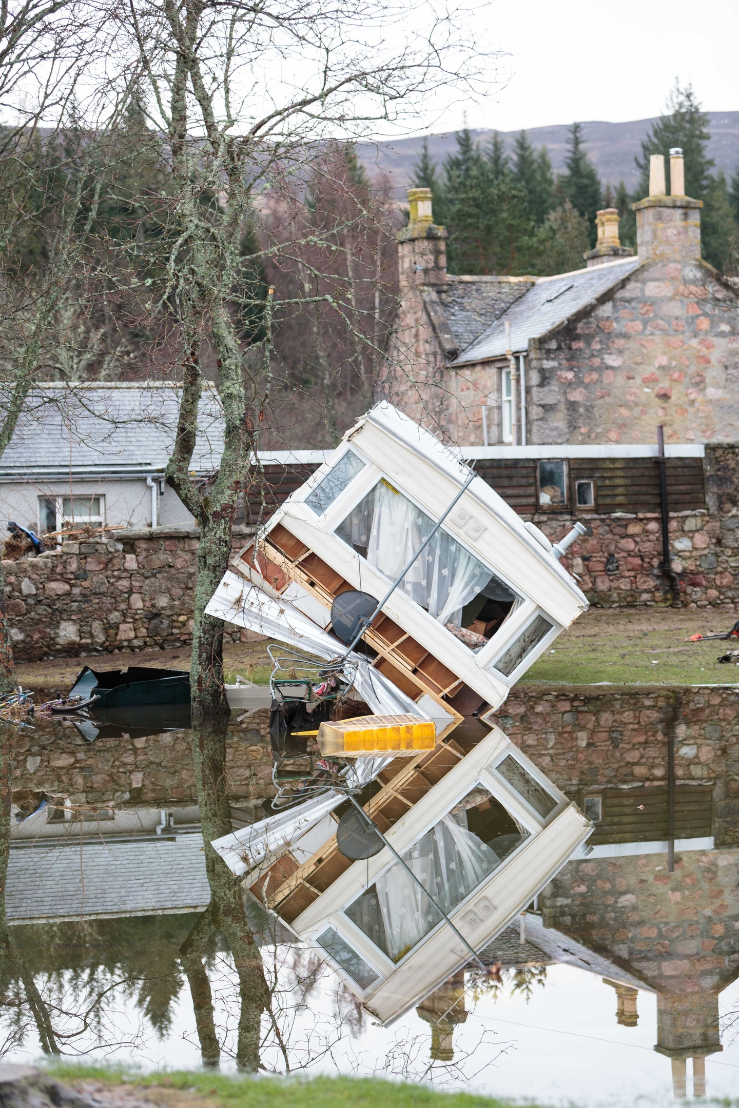 The aftermath of Storm Frank is revealed as residents of Ballater begin the clear up on New Years Eve 