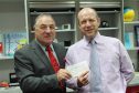 Alex Wood from Aiken Group making a donation instead of sending Christmas Cards, with Neil Skene from NESS