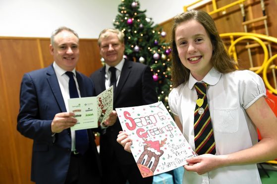 Alanna Pick, with her Christmas Card design, Richard Lochhead, MSP, left, and Angus Robertson, MP, centre.
Picture by Gordon Lennox