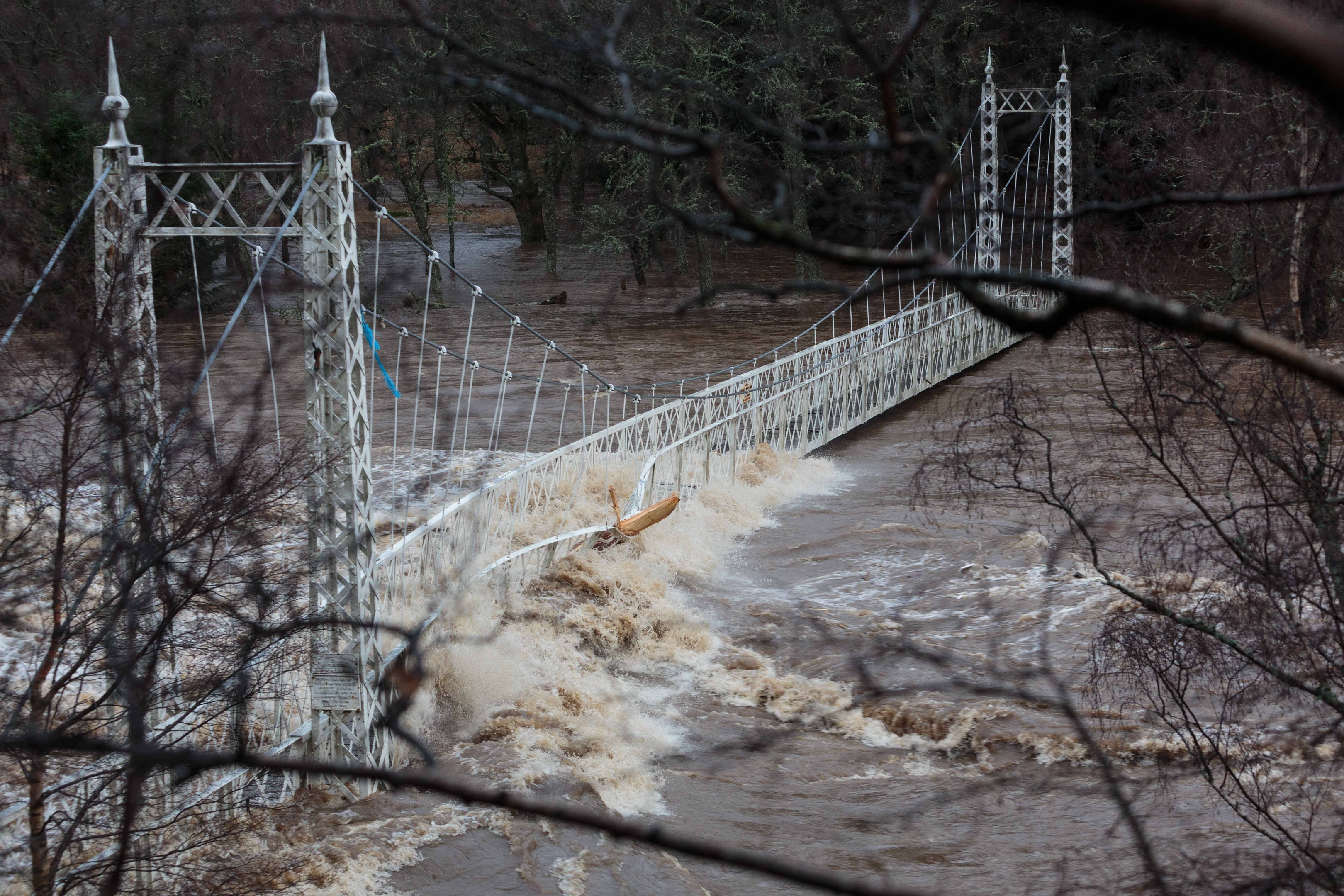 Thousands of homes in Scotland have been left without power as Storm Frank sweeps the country bringing heavy rain and gale-force winds. Pictured: The Cambus O'May footbridge over the River Dee  