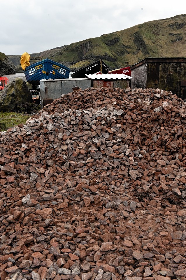 Large boulders and smaller stones at Cove  Harbour to prevent access. Picture by Colin Rennie 