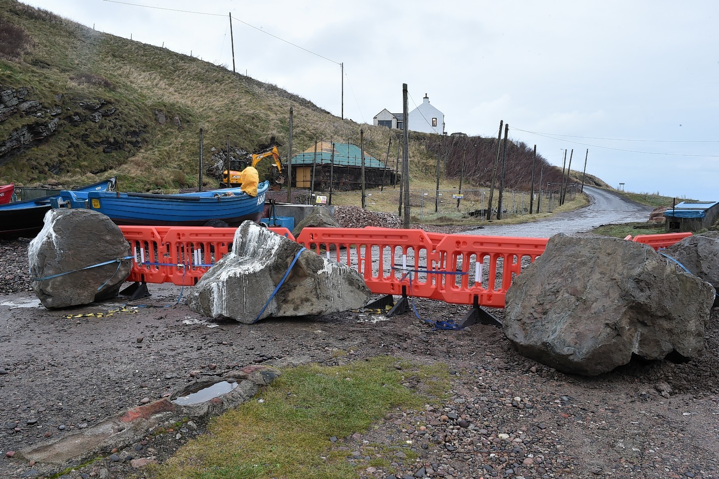 Large boulders and smaller stones arrive at Cove  Harbour to prevent access. Picture by Colin Rennie 