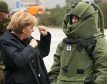 German chancellor Angela Merkel speaks to a German Army soldier who wears heavy explosion protection gear during her visit to the Army Training Center of the German Armed Forces in Letzlingen, eastern Germany.