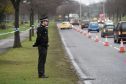 Police and forensic officers at the scene of the football pitches beside goals in Garthdee.
