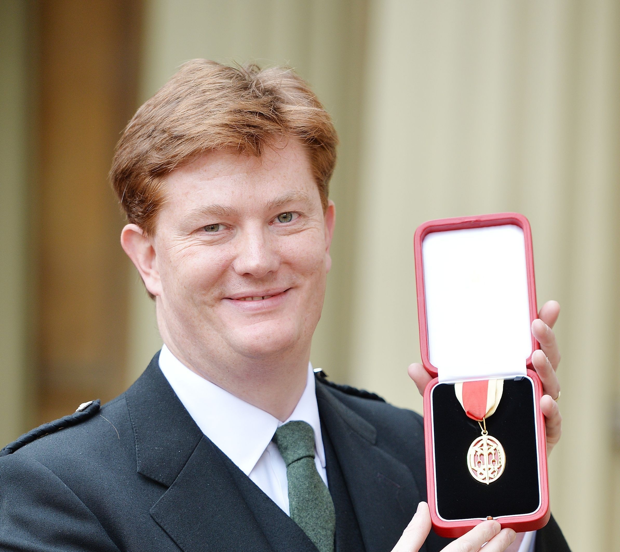 Sir Daniel Alexander holds his insignia of Knighthood which was presented by the Prince of Wales at the Investiture ceremony in Buckingham Palace,
