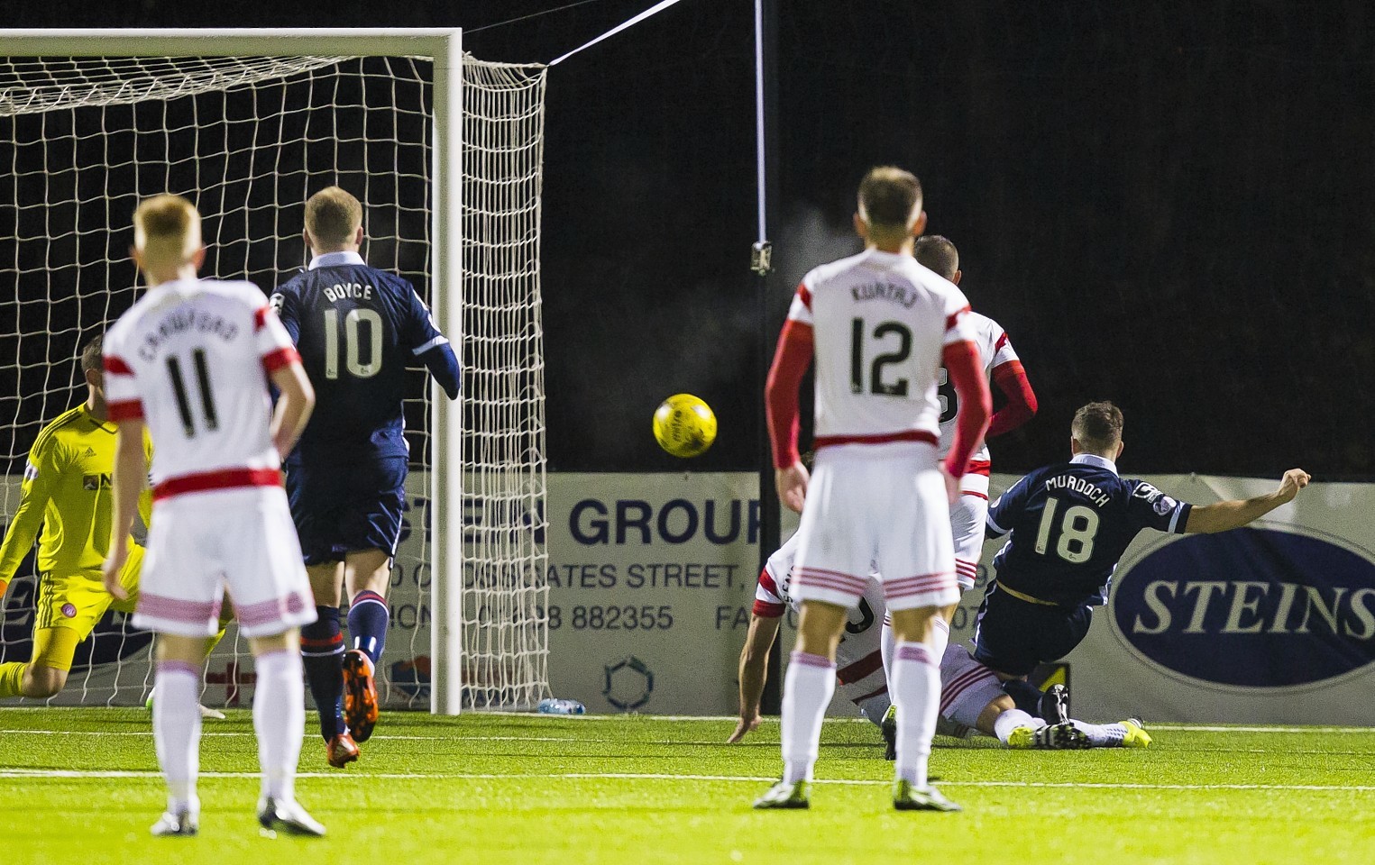 Ross County's Stewart Murdoch (right) fires the ball into the net