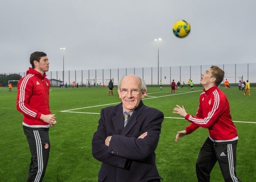 Dr George Stevenson with Aberdeen FC's Scott McKenna (left) and Scott Wright