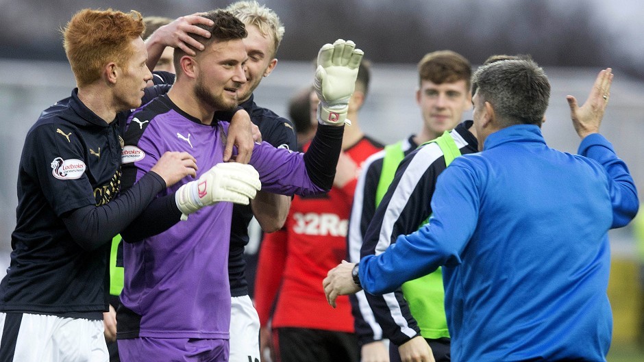 Danny Rogers, second left, celebrates with team-mates after pulling off a crucial penalty save in his side's 2-1 victory over Rangers