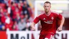 Adam Rooney struck a penalty in the final minute for the Dons
