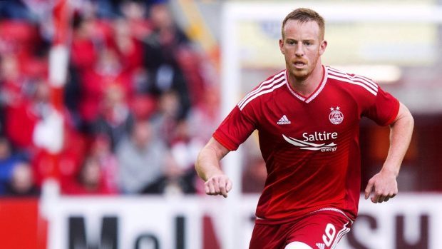 Adam Rooney struck a penalty in the final minute for the Dons