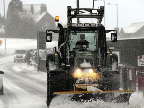 A snow plough clears the road