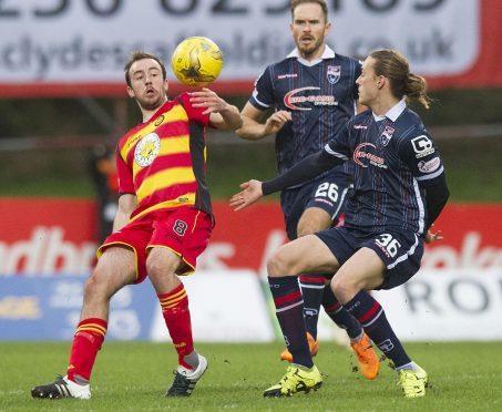 Partick Thistle's Stuart Bannigan (left) and Ross County's Jackson Irvine fight for the ball