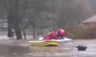 Rescuers save a man trapped in LandRover in flood waters