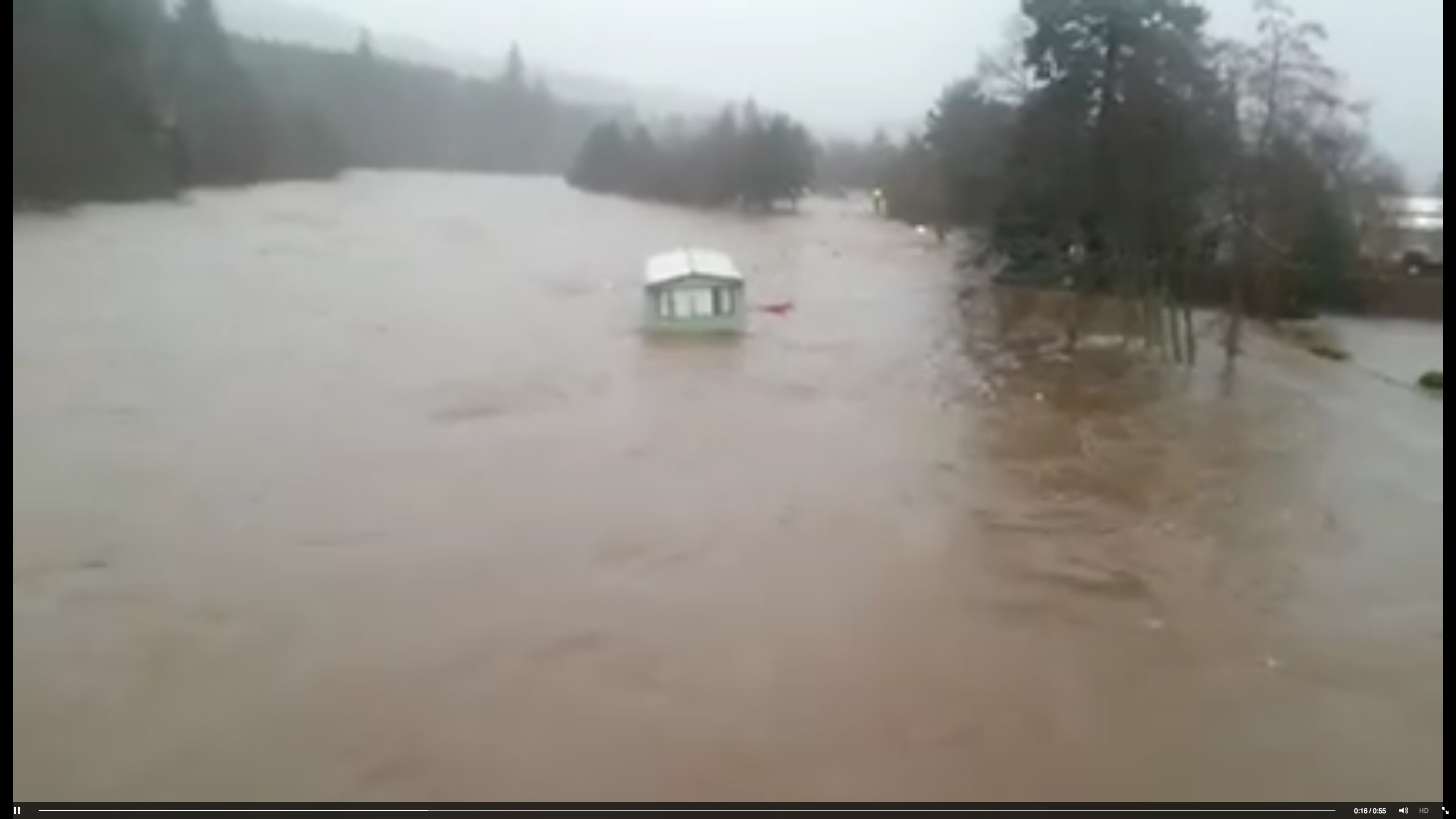 Caravan floating down River Dee