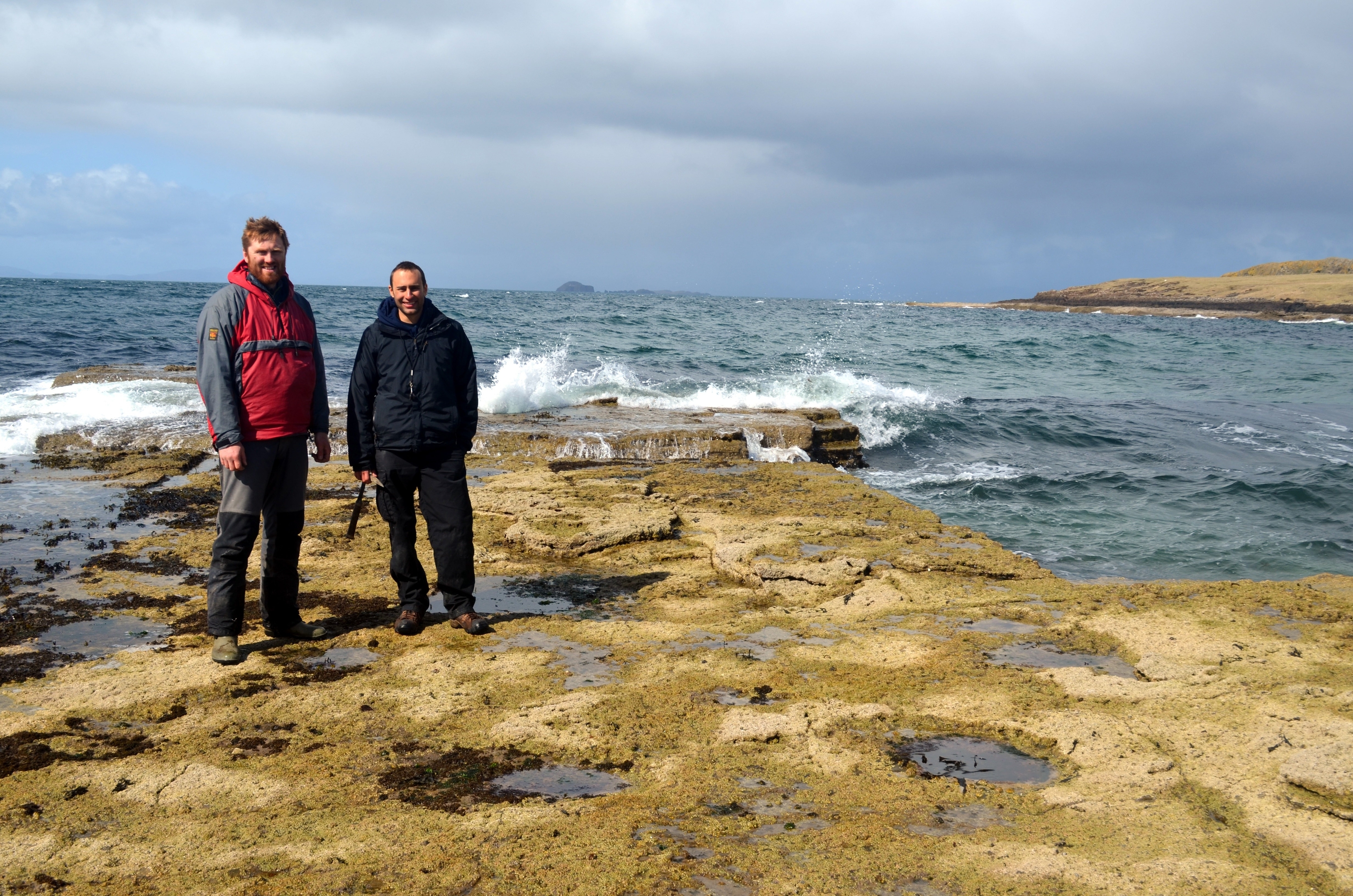 Dr Steve Brusatte (R) and Dr Tom Challands(L) by sauropod dinosaur tracks on the Isle of Skye. 