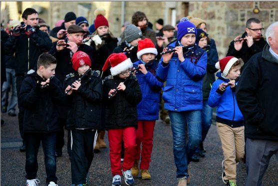 THE INVERSAINTCAIRN FLUTE BAND LEADS THE CHRISTMAS DAY WALK THROUGH THE VILLAGES OF CAIRNBULG AND INVERALLOCHY. Picture Duncan Brown