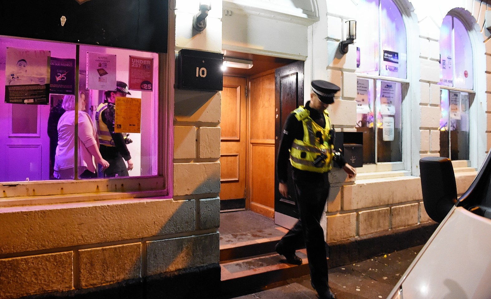 A police officer leaving Zee's bar, Stonehaven